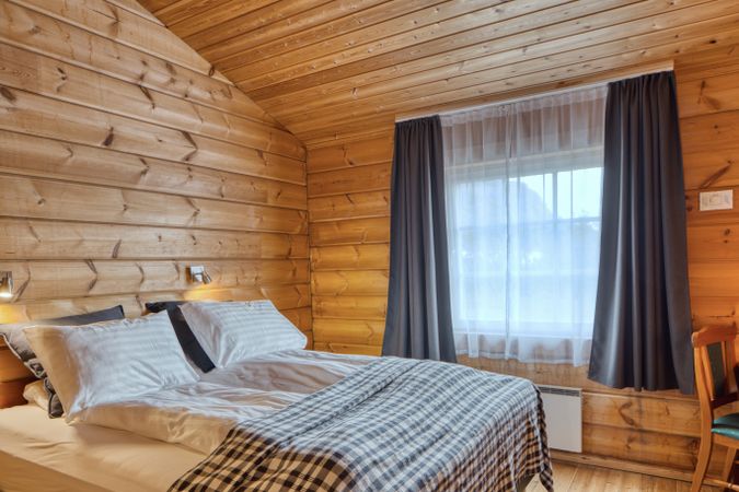 Comfortable hotel interior with wooden wall