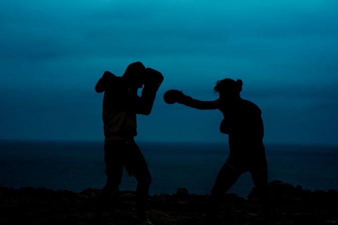 Anonymous kickboxers fighting at night