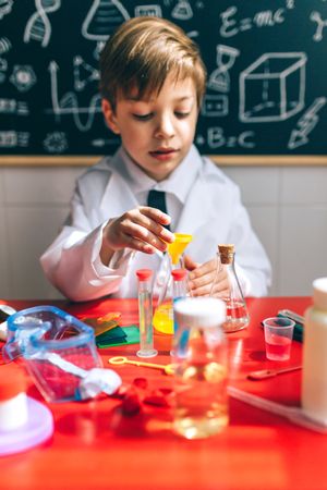 Boy playing with chemistry game set