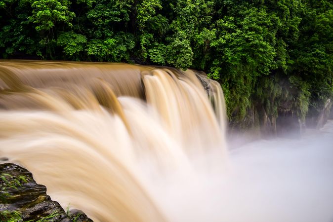 Shutter speed photography of waterfall with brown water