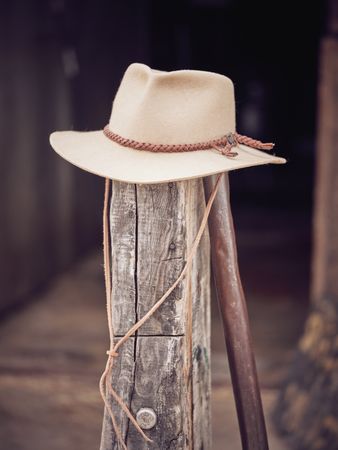 Cowboy hat on old wooden pillar