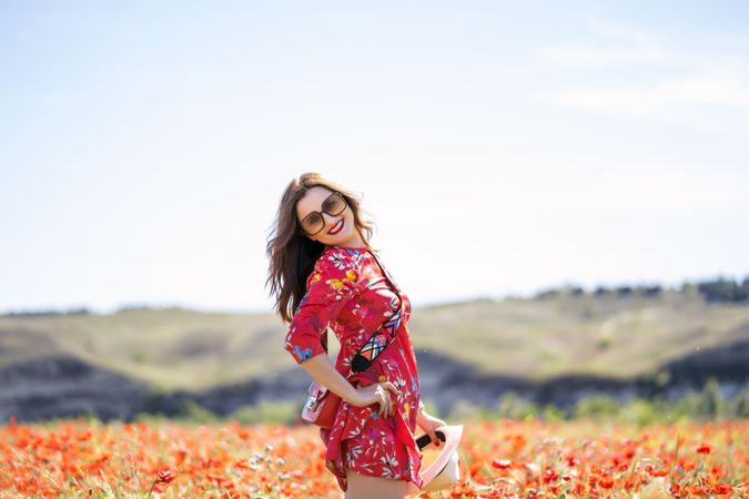 Excited woman laughing in field