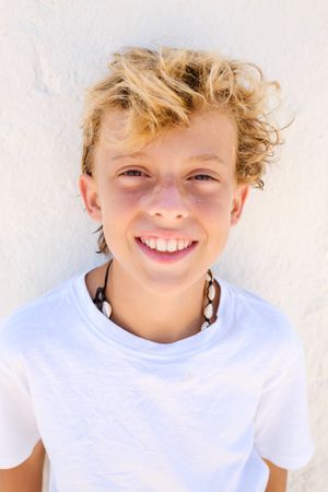 Portrait of smiling boy with curly blond hair