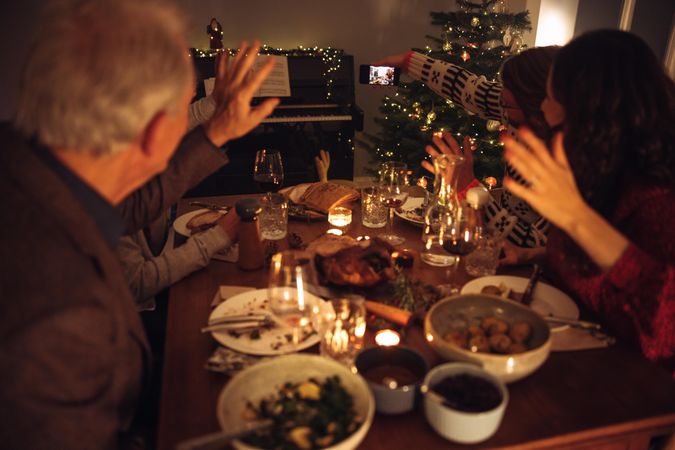 Man taking selfie with family on christmas eve dinner