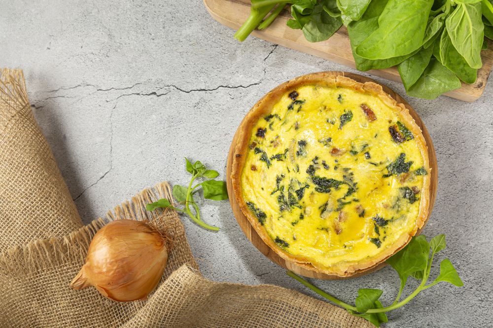 Spinach quiche with onion and bacon.