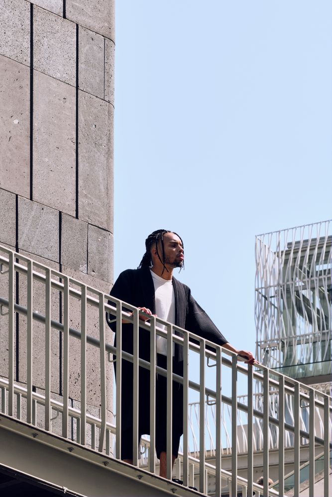 Black male standing on bridge