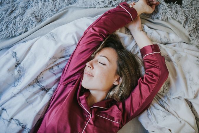 Woman sleeping and smiling in bed