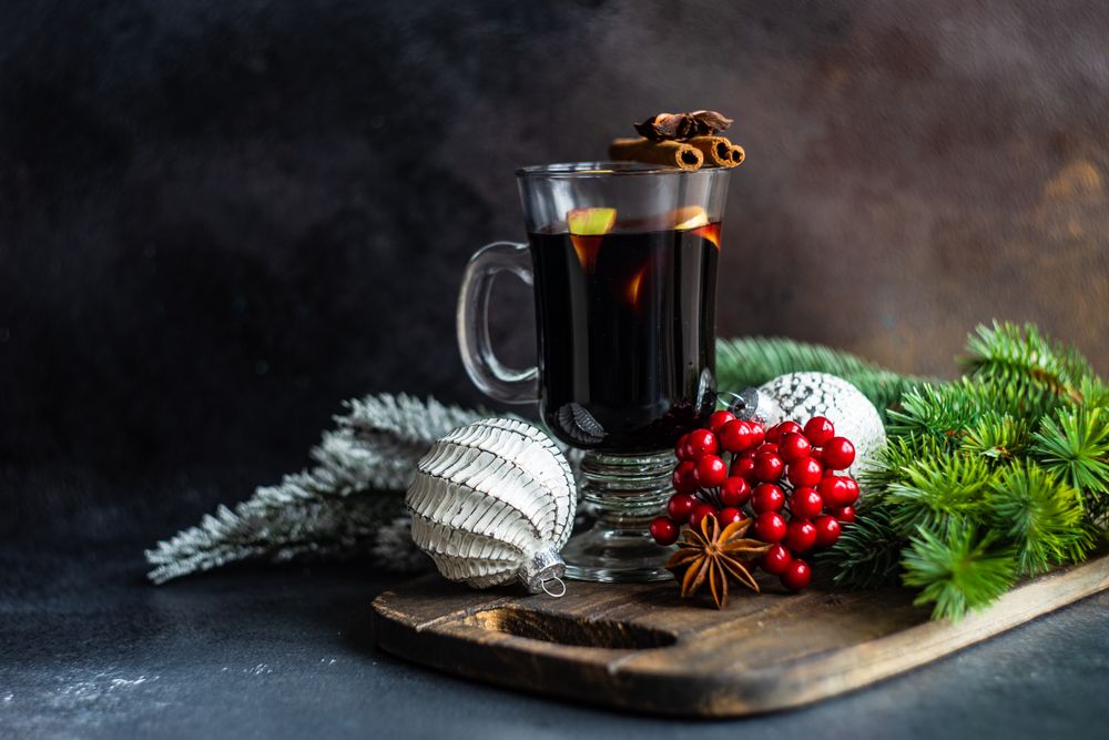 Mulled wine on bread board with Christmas baubles and decorations