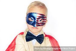 Serious blond boy wearing American flag mask 56Z8Y5