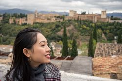 Content female enjoying view of big ancient castle