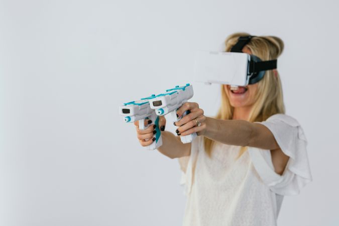Woman in VR headset playing videogame