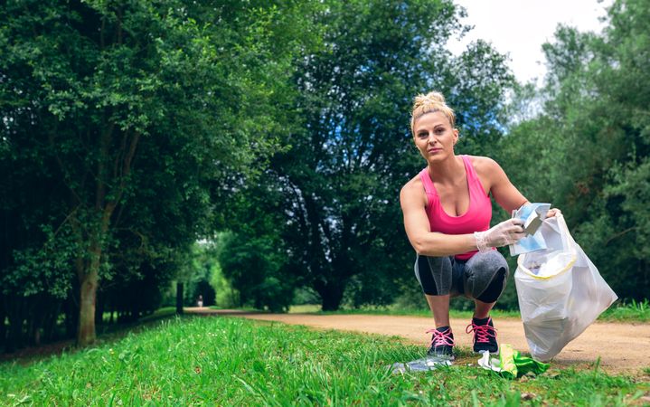 Woman picking up trash doing plogging