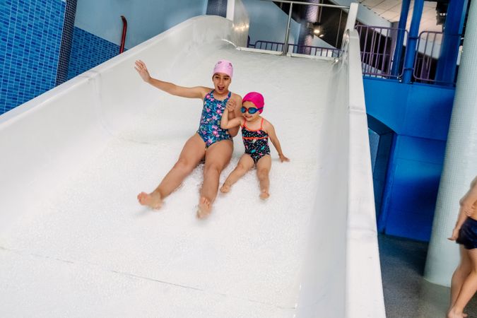 happy girls sliding in water park