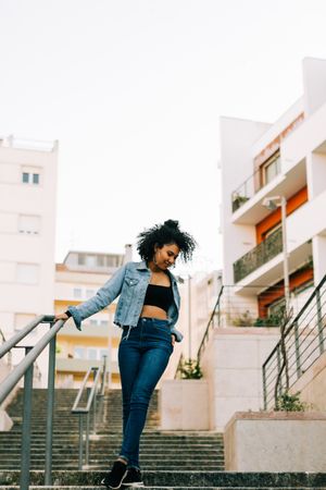 Trendy young female laughing on stairs