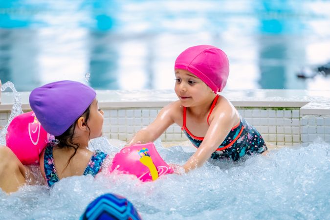 girls with water wings in swimming pool