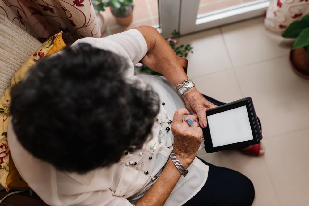 Mature female reading e-book at home