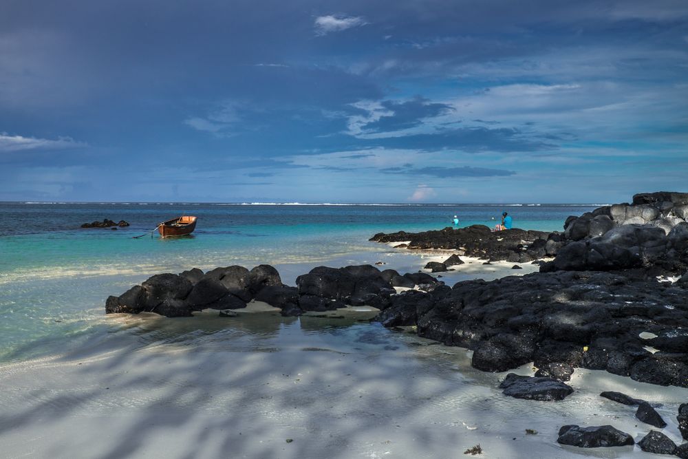 Red boats near lava rock in the Indian Ocean
