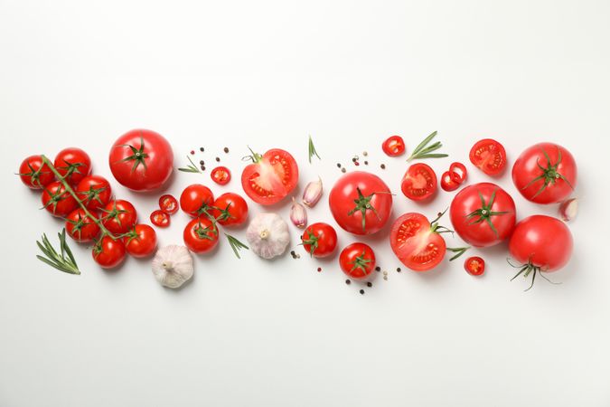 Composition with tomatoes and ingredients on light background, top view