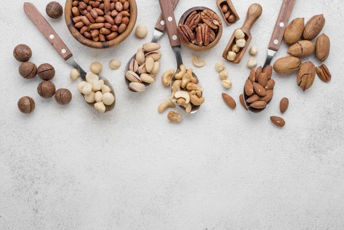 Arrangement of different kinds nuts on bright background