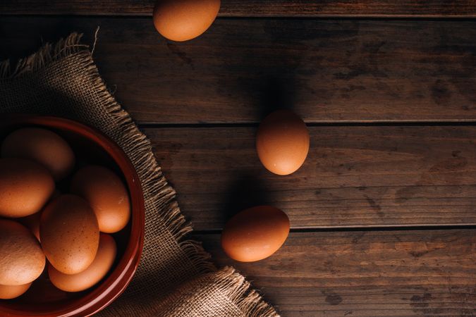 Chicken eggs on napkin on wooden table