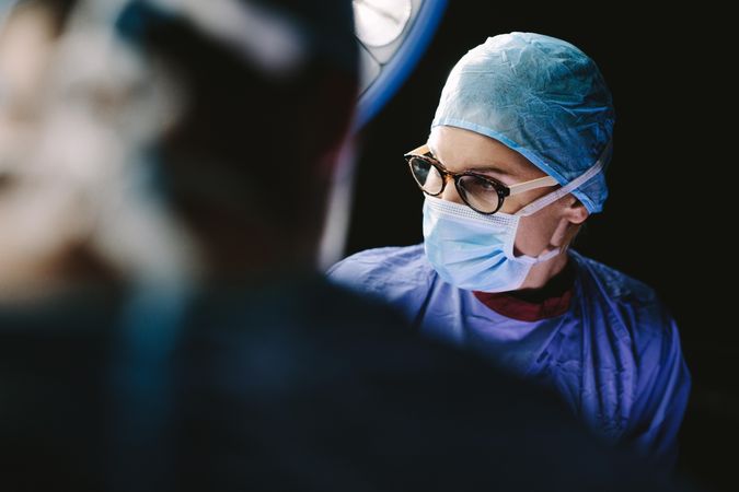 Close up of woman surgeon concentrating while performing surgery