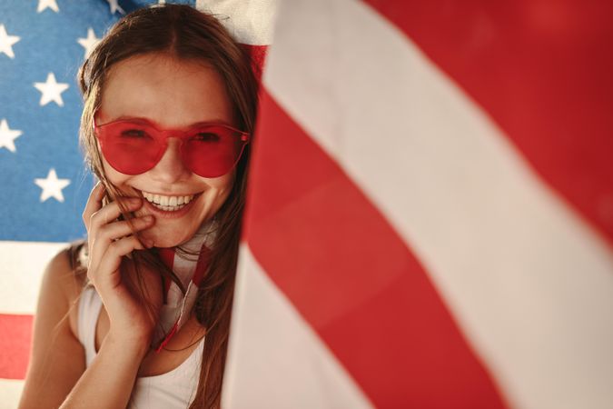 Cheerful American woman with national flag