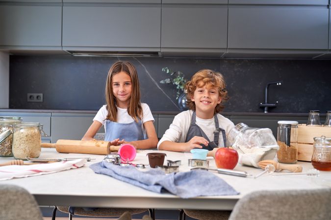 Cheerful children making cookies together