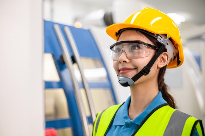 Asian woman in safety gear in factory