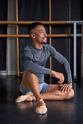 Photo portrait of a Black dancer with sport clothes and slippers and ballet in a dance academy