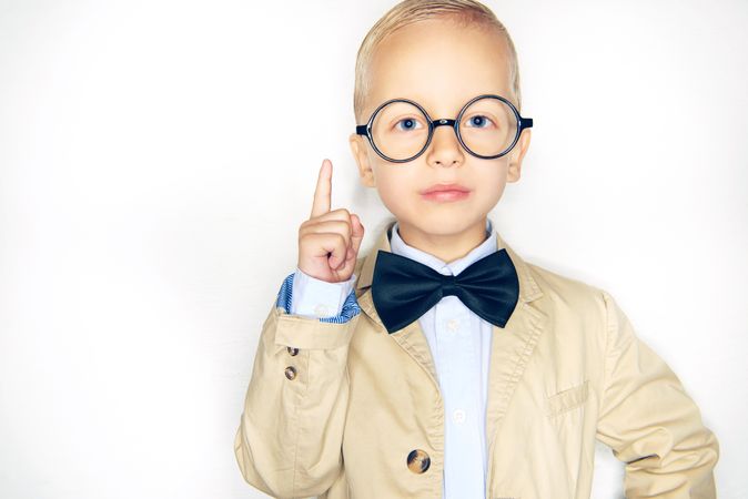 Clever blond boy in glasses and bow tie