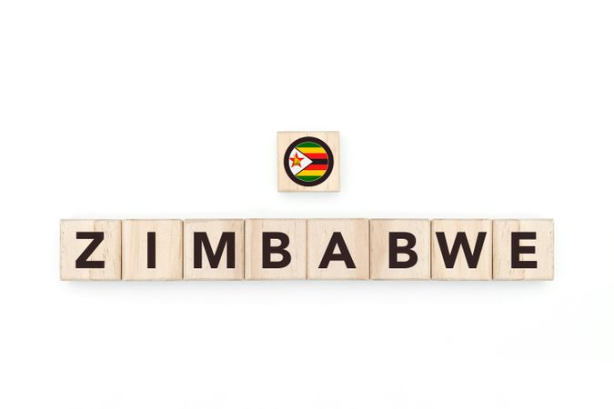Wooden blocks bearing the name and flag of Zimbabwe. Zimbabwean and South African Culture, national identity, travel, and geography in a copy space design.