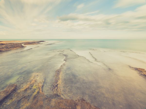 Rocky seashore under blue sky