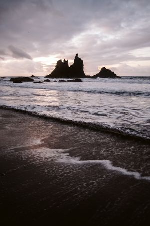 Lonely cliff in sea on cloudy day