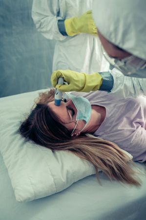 Patient attended by doctors who check if she has fever