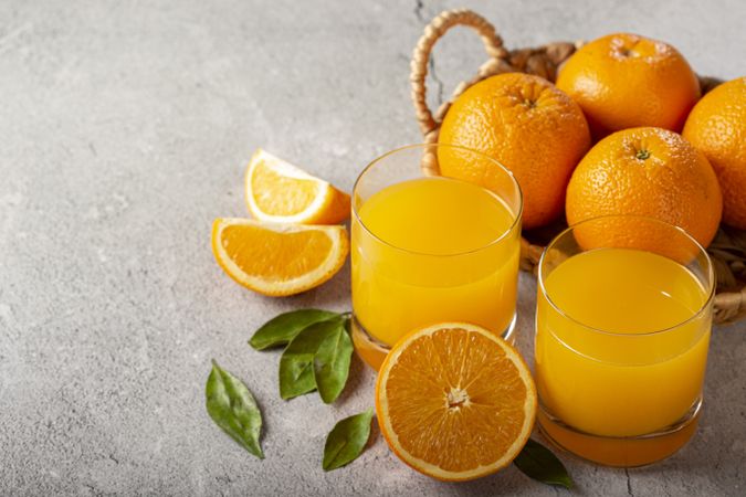 Glass with orange juice on the table.