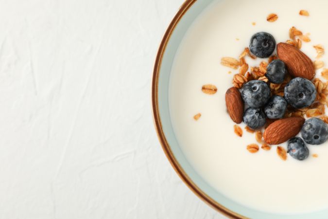 Bowl with parfaits dessert on plain cement background