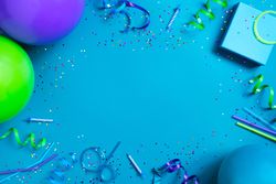 Birthday party trinkets framing a blue background