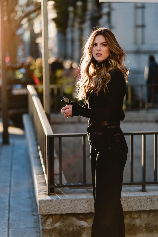 Stylish woman standing near metro station