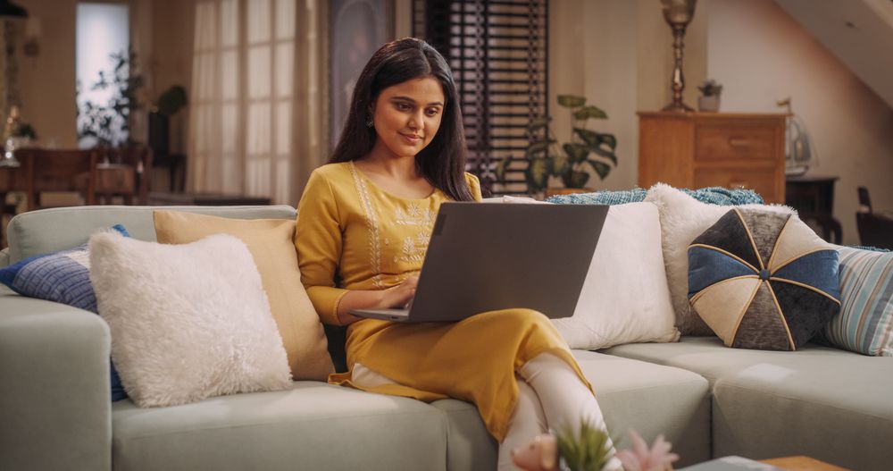 Woman Engaged in Laptop Use at Home, does Work Projects, and Efficiently Leading Her Remote Team