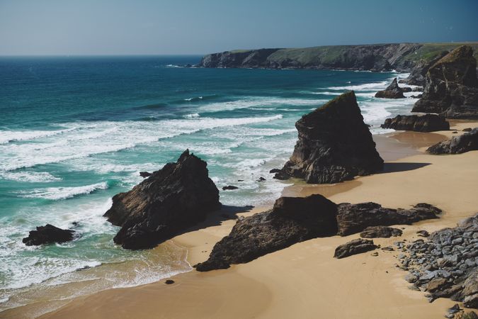 Cliffs surrounding a rugged British beach with sand