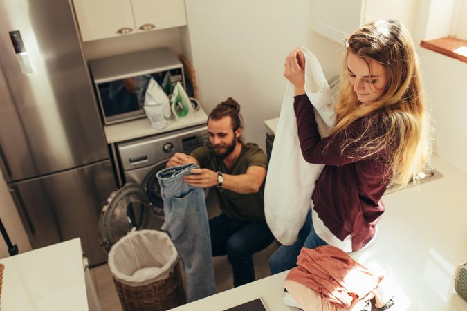 Couple doing their laundry work together at home
