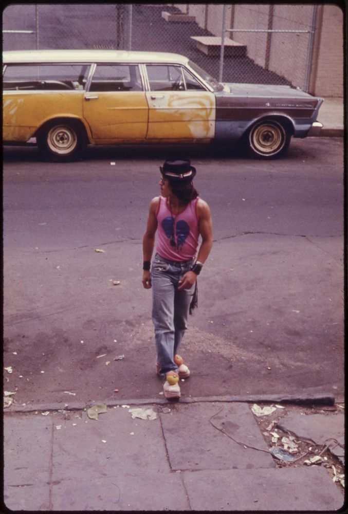 Trendy hispanic man crossing the street in New Jersey 1974