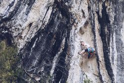 Anonymous man climbing rock