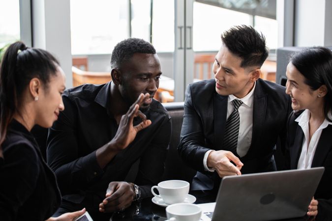 Diverse businesspeople having business meeting at a cafe