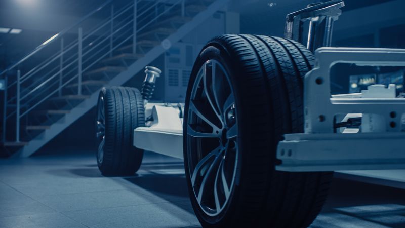 Shot of Automobile Concept: Authentic Electric Car Platform Chassis. Hybrid Frame Include: Wheels, Engine, Brakes and Battery.