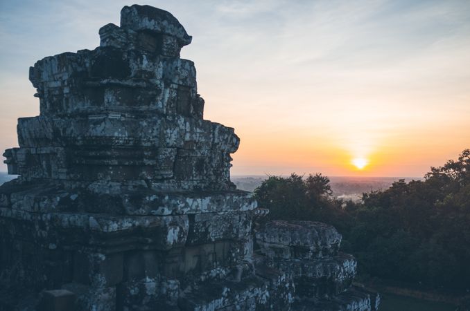 Ancient temple against sunset sky