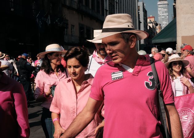 Mexico City, Mexico - February 26th, 2022: Man and woman dressed in pink walking with protesters