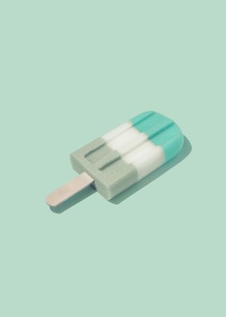 Colorful ice cream popsicle on pastel pink background