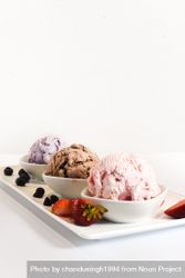 Plate of three different flavored ice cream scoops, vertical 4mA2v4