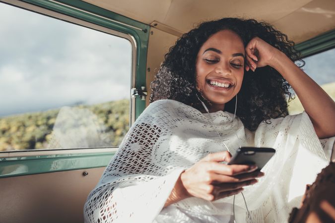 Black woman on road trip traveling by van